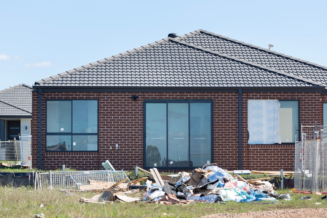 Detritos De Construcao Empilhados Em Frente a Uma Casa De Tijolos Fvw7bArYMbE