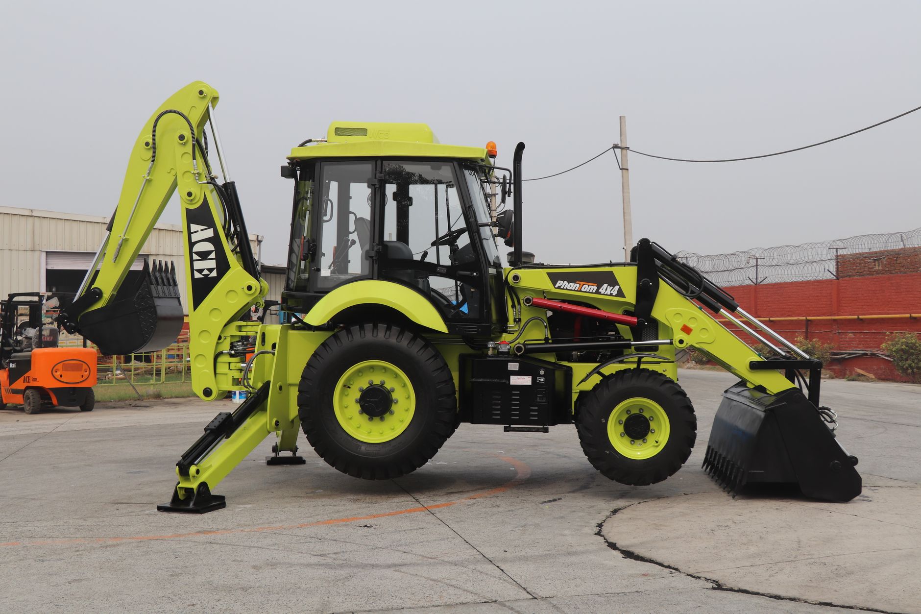 Image of ACE Phantom 4x4 backhoe loader parked on an outdoor construction site in India.