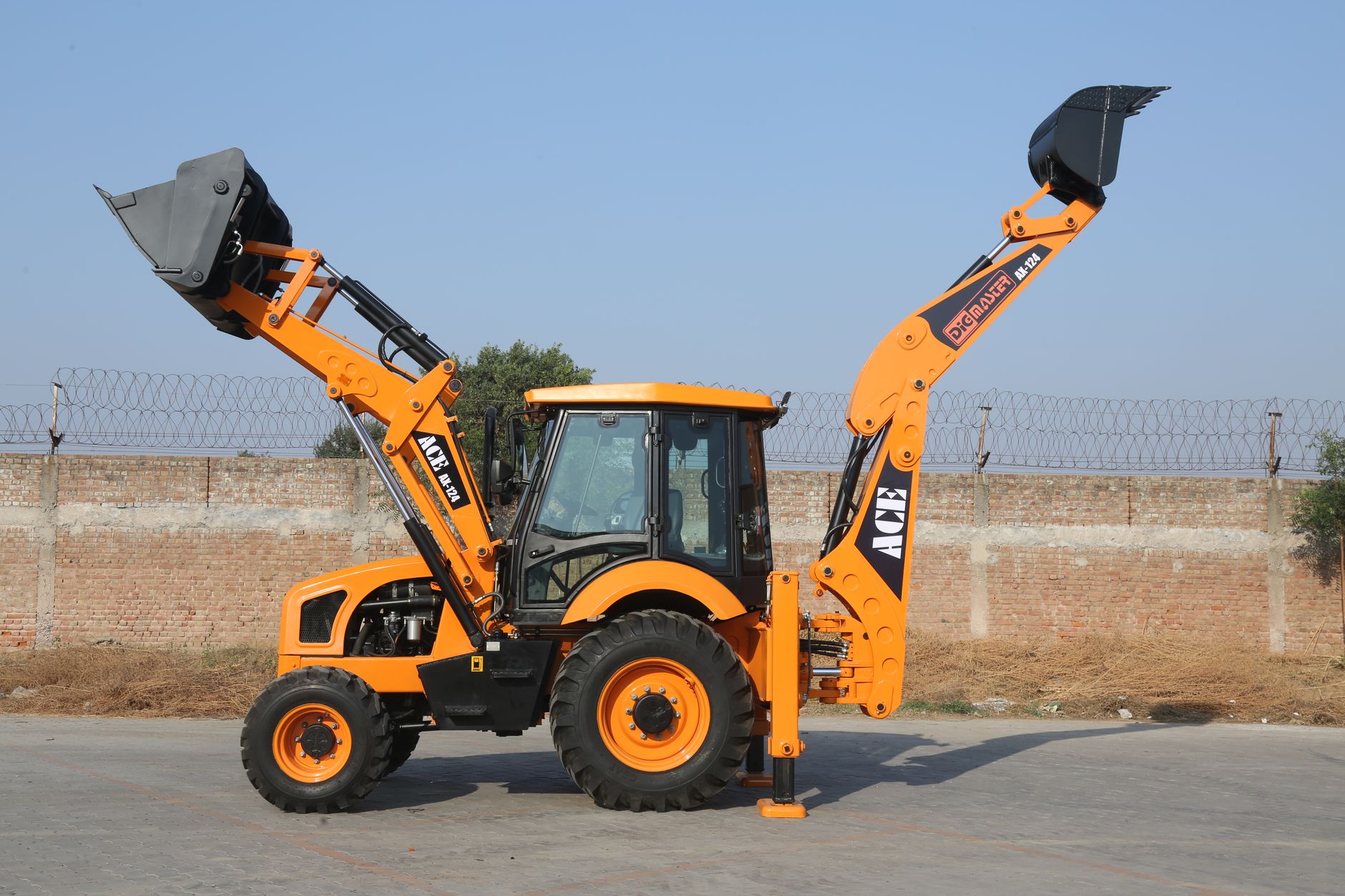 High-quality image of ACE AX 124 backhoe loader outdoors in India.