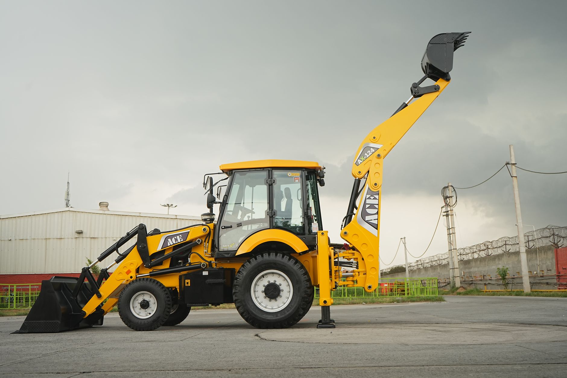 Yellow ACE backhoe loader at a construction site in Faridabad, Haryana, India.